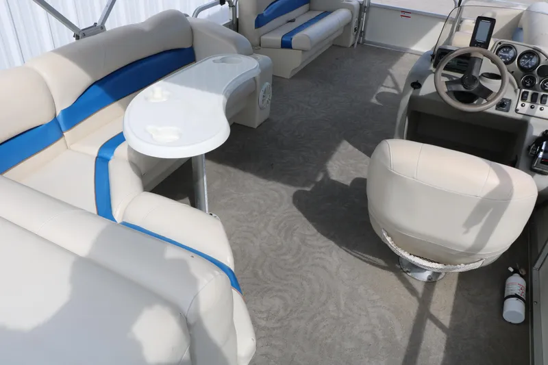 Slide: The Image of Interior of a 2008 Sun Cruiser SS200 boat with beige and blue seating. - 23