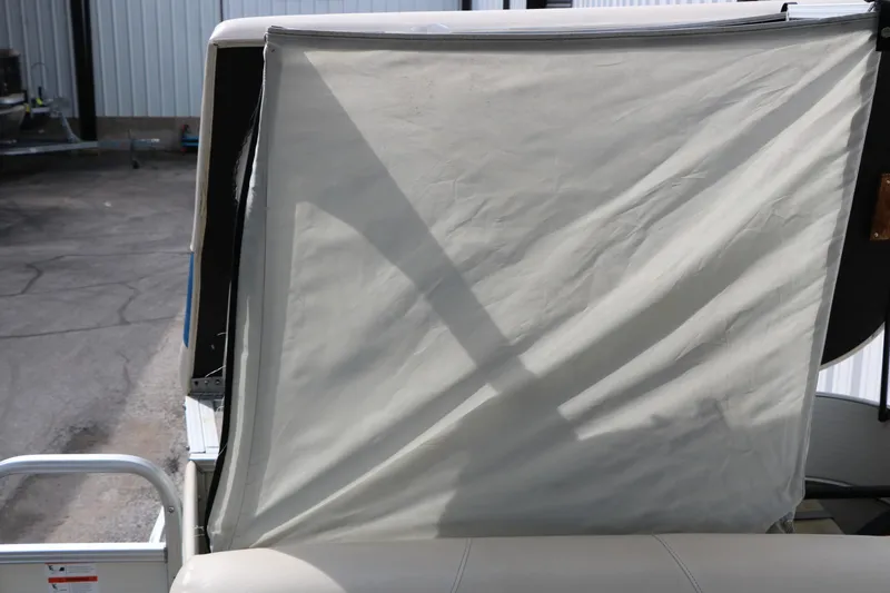 Slide: The Image of 2008 Sun Cruiser SS200 boat with a partially open canopy in a parking area. - 24
