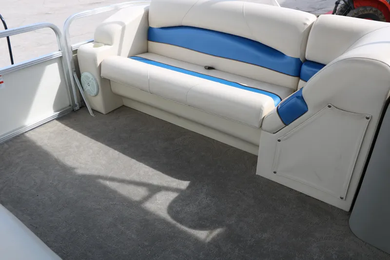 Slide: The Image of 2008 Sun Cruiser SS200 boat interior with blue and white seating. - 25