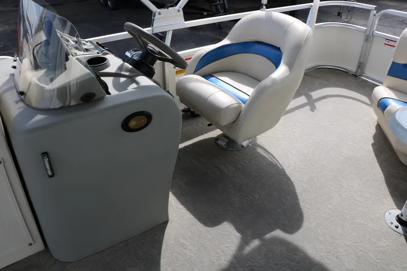 Slide: The Image of 2008 Sun Cruiser SS200 boat interior with steering console and cushioned seating. - 26