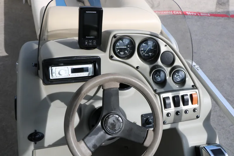 Slide: The Image of 2008 Sun Cruiser SS200 boat dashboard with steering wheel, gauges, and controls. - 28