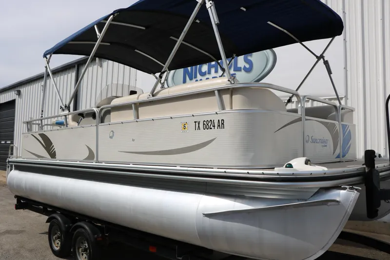 Slide: The Image of 2008 Sun Cruiser SS200 pontoon boat with canopy, parked on a trailer. - 3