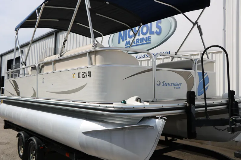 Slide: The Image of 2008 Sun Cruiser SS200 pontoon boat on trailer, parked outside Nichols Marine. - 36
