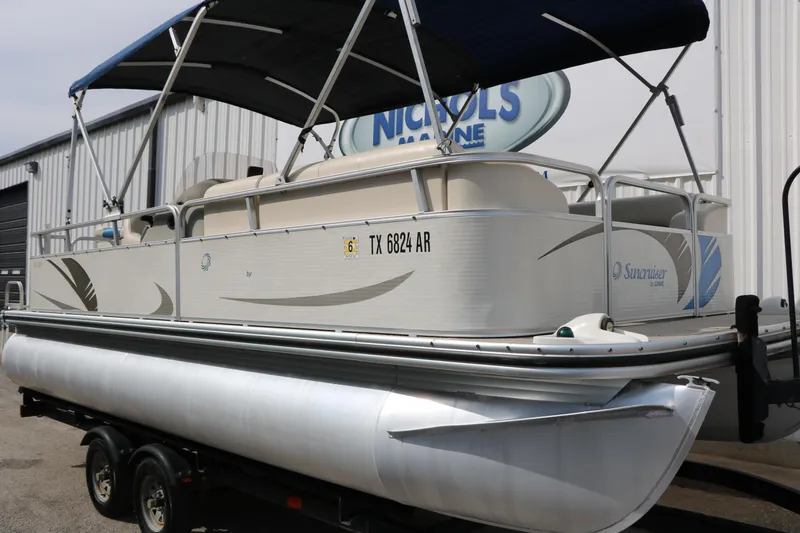 Slide: The Image of 2008 Sun Cruiser SS200 pontoon boat with canopy on trailer, parked outside. - 7