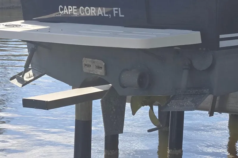 Slide: The Image of 2009 Mainship Pilot 31 boat stern view, Cape Coral, FL, docked in water. - 11