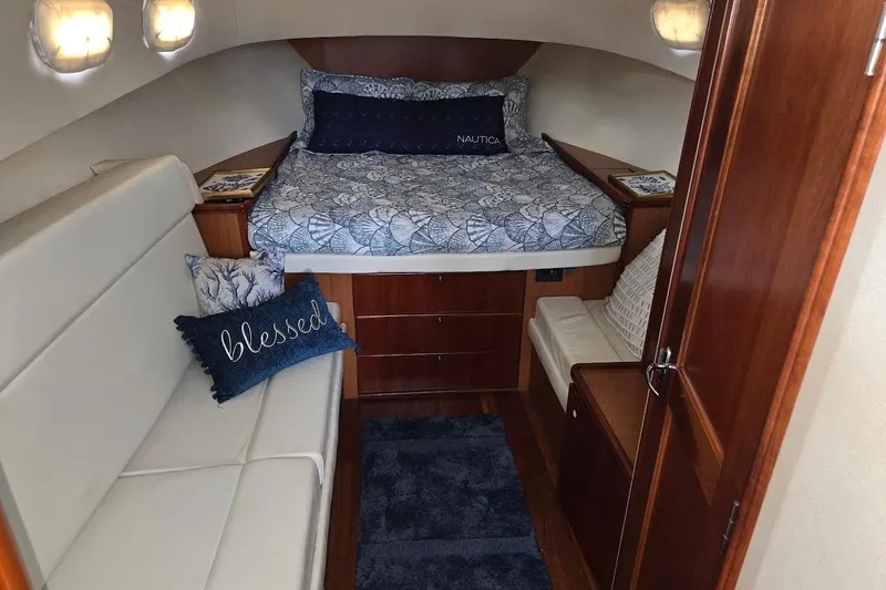 Slide: The Image of 2009 Mainship Pilot 31 cabin interior with cozy bed and seating area. - 12