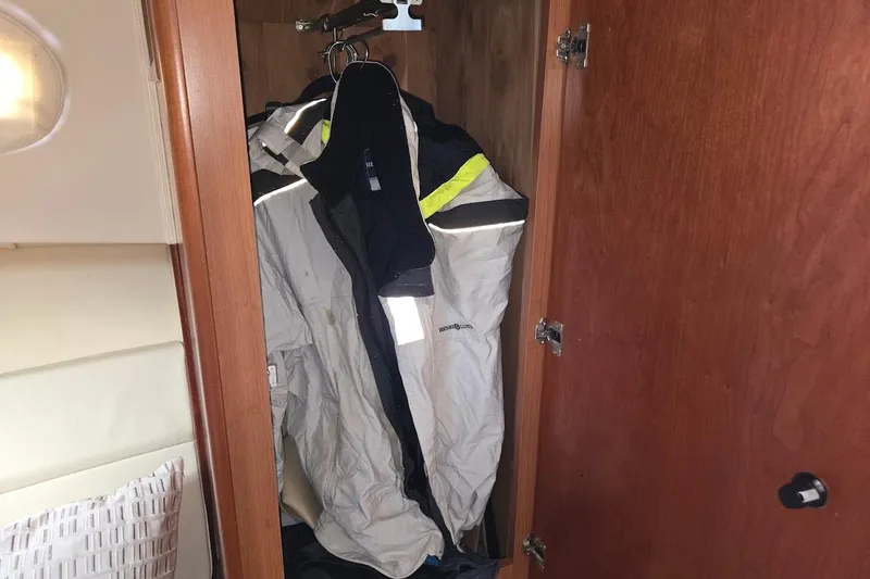 Slide: The Image of Closet with jackets inside a 2009 Mainship Pilot 31 boat. - 17