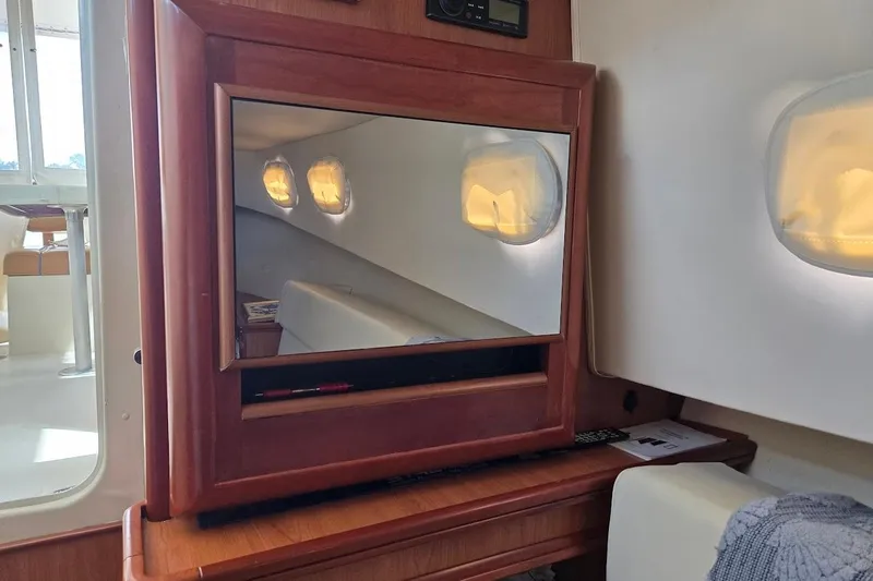 Slide: The Image of Interior of 2009 Mainship Pilot 31 with wooden cabinetry and cozy seating area. - 21