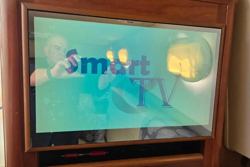 Slide: The Image of Smart TV screen inside a 2009 Mainship Pilot 31 boat cabin. - 22