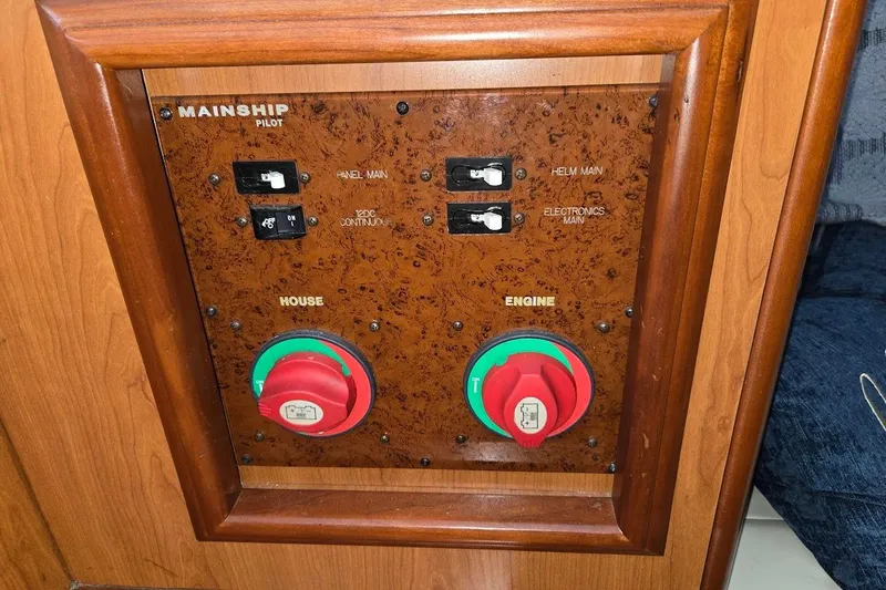 Slide: The Image of Control panel of a 2009 Mainship Pilot 31 boat with switches and dials. - 25