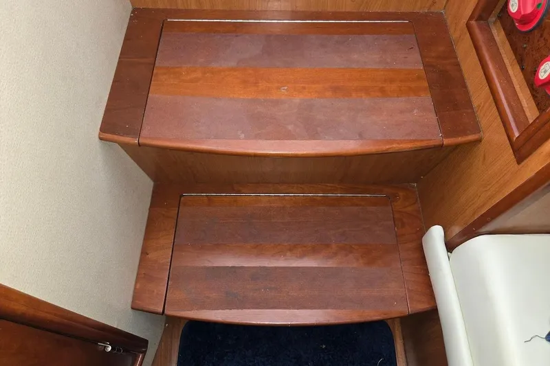 Slide: The Image of Wooden steps inside a 2009 Mainship Pilot 31 boat, featuring polished finish. - 27