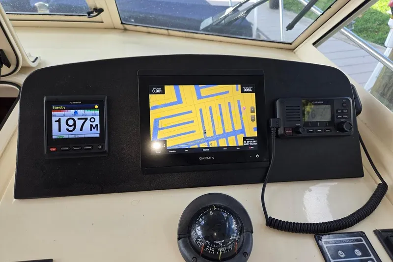 Slide: The Image of 2009 Mainship Pilot 31 helm with Garmin navigation and communication systems. - 3