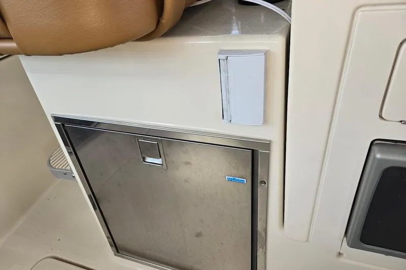 Slide: The Image of 2009 Mainship Pilot 31 interior with stainless steel cabinet and tan seating. - 35