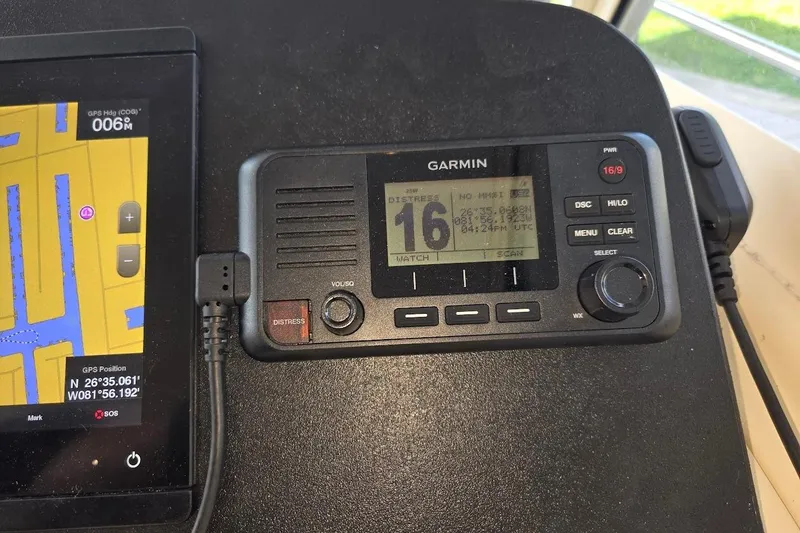Slide: The Image of Garmin marine radio and GPS display on 2009 Mainship Pilot 31 boat dashboard. - 44