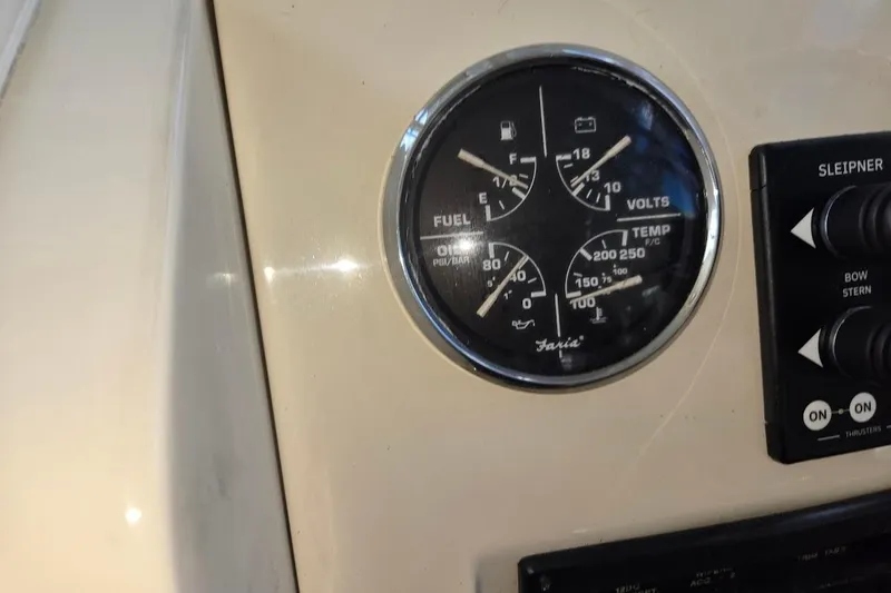 Slide: The Image of Dashboard of a 2009 Mainship Pilot 31 with fuel and temperature gauges. - 46