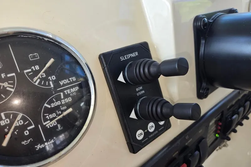 Slide: The Image of 2009 Mainship Pilot 31 dashboard with gauges and Sleipner thruster controls. - 47