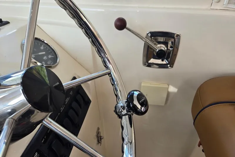 Slide: The Image of Steering wheel and controls of 2009 Mainship Pilot 31 boat cockpit. - 48