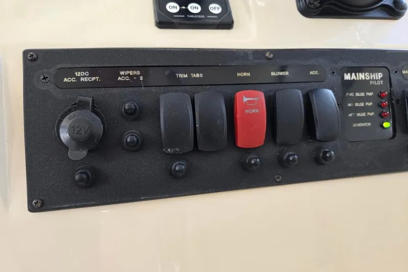 Slide: The Image of Control panel of a 2009 Mainship Pilot 31 boat with switches and indicators. - 51