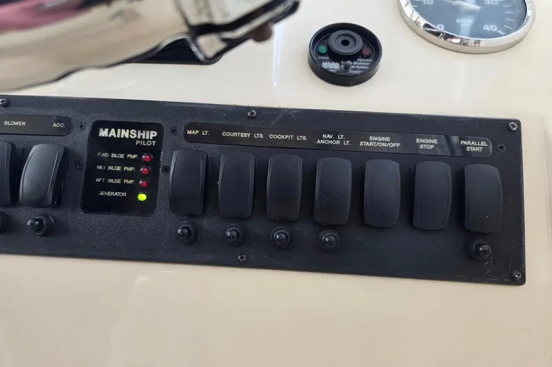 Slide: The Image of Control panel of 2009 Mainship Pilot 31 boat with labeled switches and indicators. - 52