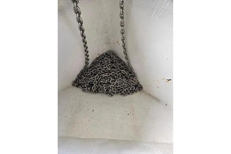 Slide: The Image of Anchor chain in a 2009 Mainship Pilot 31 boat compartment. - 62