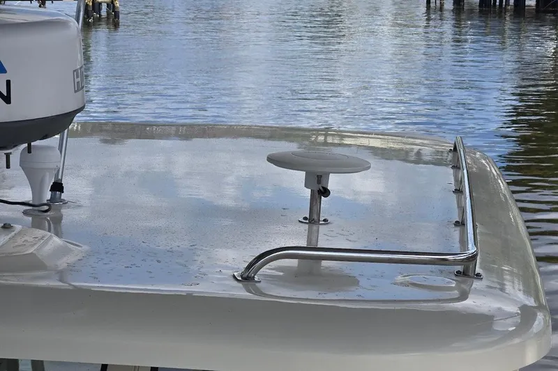 Slide: The Image of 2009 Mainship Pilot 31 boat deck with radar, docked on calm water. - 65