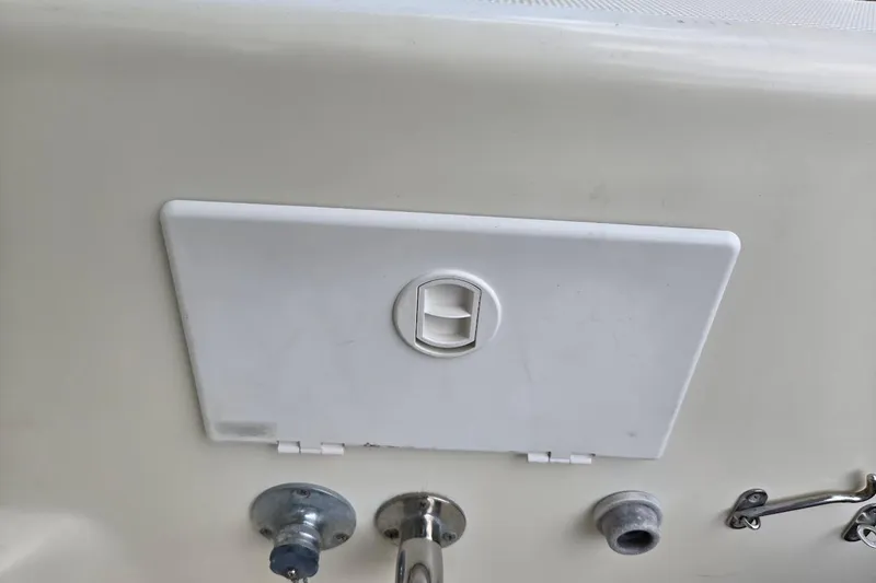Slide: The Image of Access panel on 2009 Mainship Pilot 31 boat, featuring latch and fittings. - 66