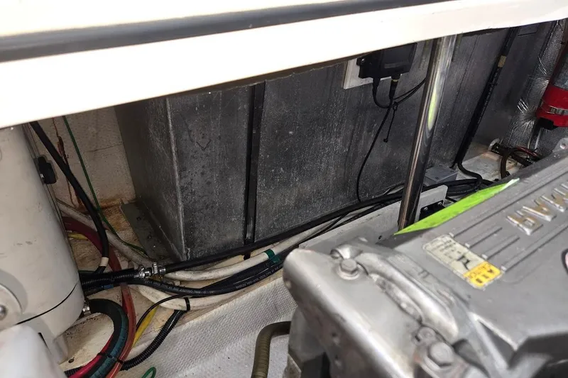 Slide: The Image of Engine compartment of a 2009 Mainship Pilot 31 boat, showing mechanical components and wiring. - 68