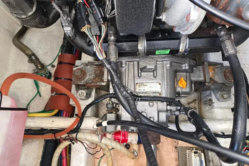 Slide: The Image of Engine compartment of a 2009 Mainship Pilot 31 boat, showcasing wiring and mechanical components. - 70