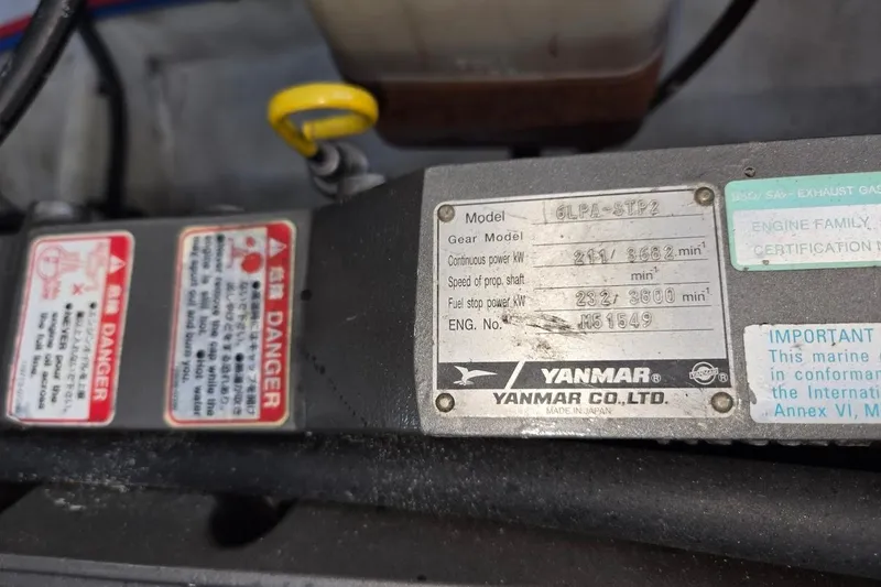 Slide: The Image of Yanmar engine label on a 2009 Mainship Pilot 31 boat, showing specifications and warnings. - 72