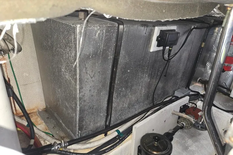 Slide: The Image of Engine compartment of a 2009 Mainship Pilot 31 boat, showing wiring and components. - 76