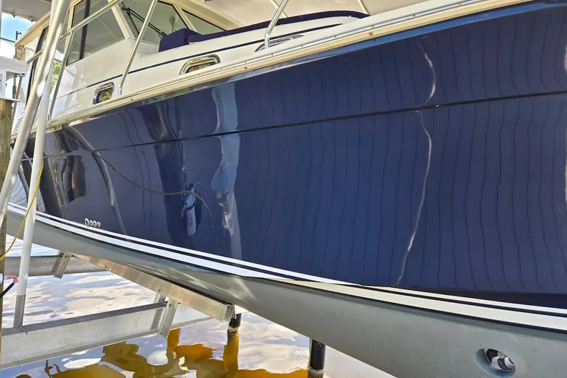 Slide: The Image of 2009 Mainship Pilot 31 boat with sleek blue hull on a lift. - 81