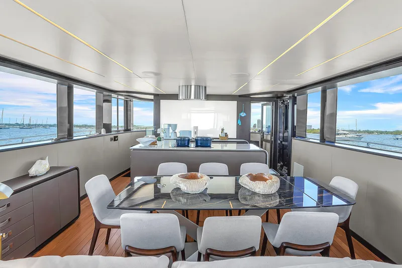 Slide: The Image of Luxurious interior of 2021 OKEAN 80 yacht with elegant dining area and panoramic windows. - 19