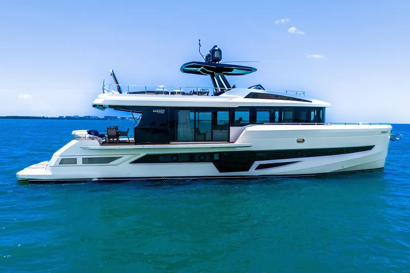 Slide: The Image of Luxury 2021 OKEAN 80 yacht cruising on clear blue ocean waters. - 4