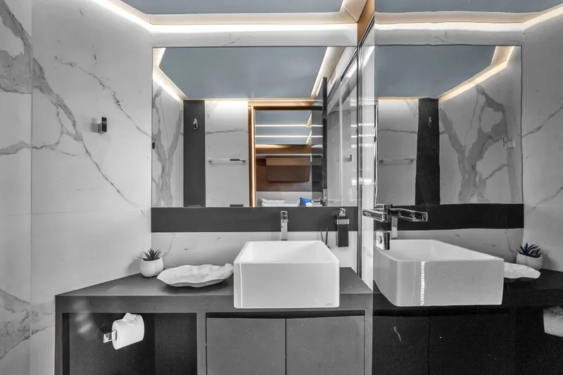 Slide: The Image of Modern bathroom with dual sinks and marble walls on OKEAN 80 yacht, 2021 model. - 44