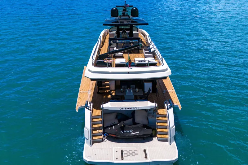 Slide: The Image of Luxury 2021 OKEAN 80 yacht on blue ocean waters, showcasing elegant design and spacious deck. - 5