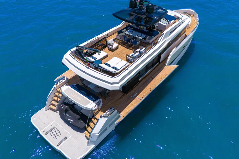 Slide: The Image of Luxury 2021 OKEAN 80 yacht on blue ocean, showcasing spacious deck and modern design. - 9