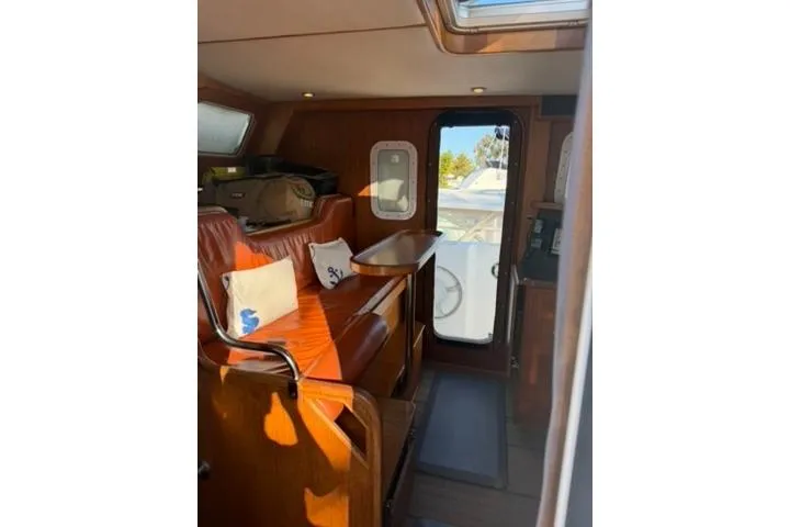 Slide: The Image of Interior of 2001 Nordhavn 40 yacht with wooden seating and nautical decor. - 10