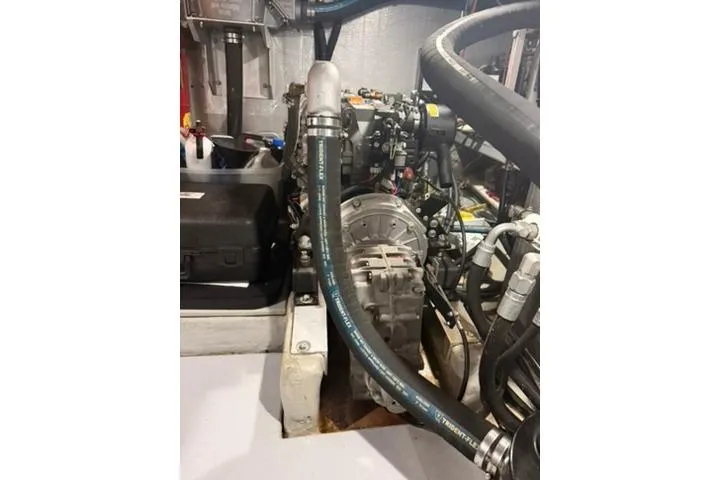 Slide: The Image of Engine room of a 2001 Nordhavn 40 boat, showcasing mechanical components and hoses. - 18