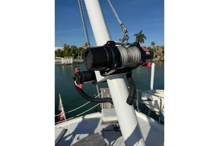 Slide: The Image of Winch mechanism on 2001 Nordhavn 40 yacht, docked by palm trees and water. - 28
