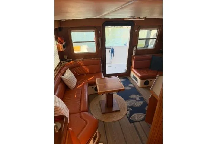 Slide: The Image of Interior of 2001 Nordhavn 40 yacht with cozy seating and wooden table. - 3