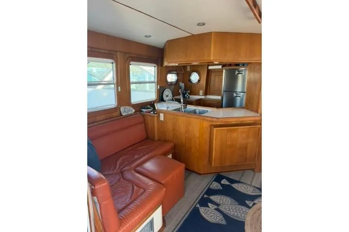 Slide: The Image of Interior of 2001 Nordhavn 40 yacht with wooden cabinetry and leather seating. - 6