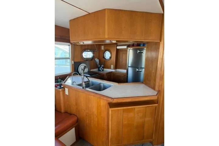 Slide: The Image of Kitchen area of a 2001 Nordhavn 40 yacht with wooden cabinetry and stainless steel appliances. - 8