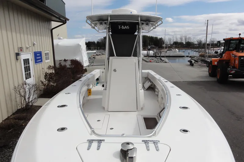 Slide: The Image of 2012 Contender 25 Tournament boat docked near a marina, showcasing its spacious deck. - 13