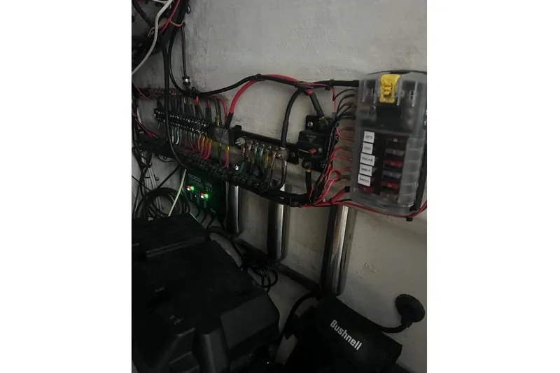 Slide: The Image of Electrical wiring and fuse box inside a 2012 Contender 25 Tournament boat. - 2