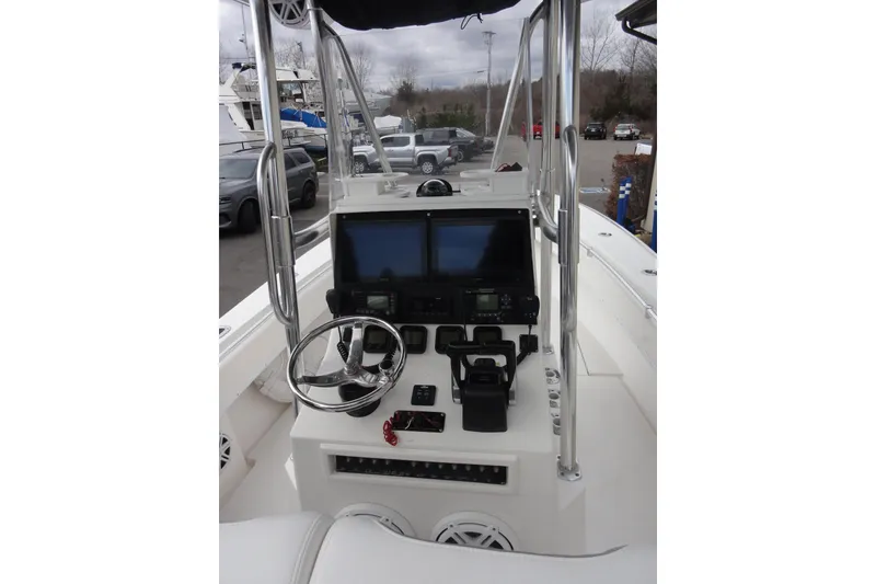 Slide: The Image of Center console of a 2012 Contender 25 Tournament boat with dual screens and steering wheel. - 22