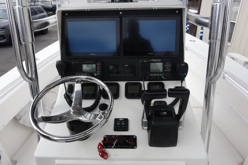 Slide: The Image of Control panel of a 2012 Contender 25 Tournament boat with dual screens and steering wheel. - 23