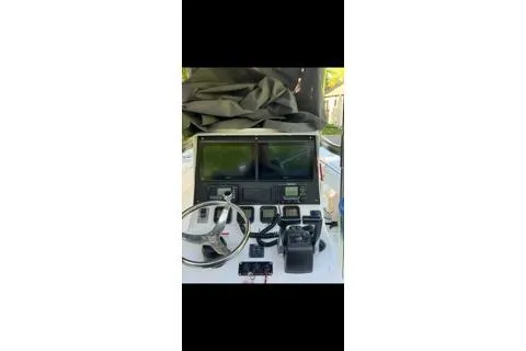 Slide: The Image of 2012 Contender 25 Tournament boat dashboard with navigation equipment and controls. - 5
