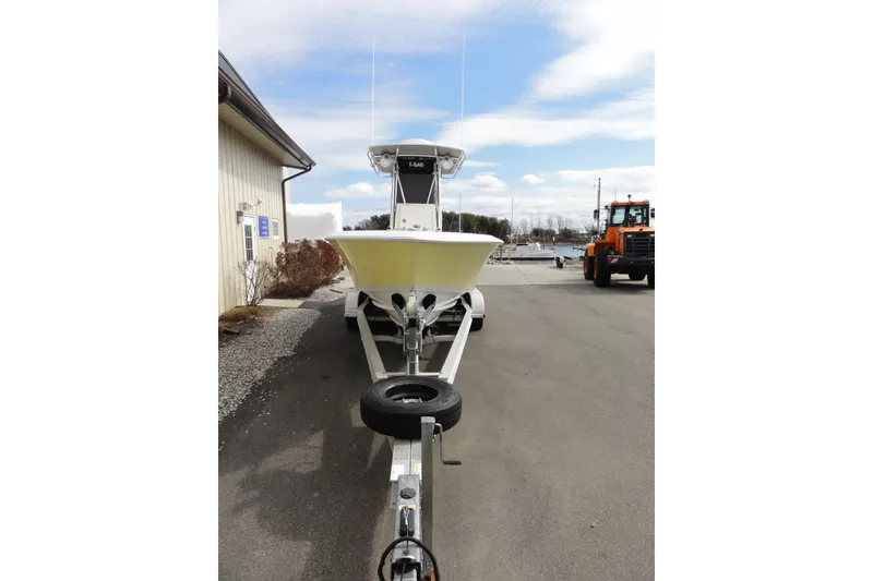 Slide: The Image of 2012 Contender 25 Tournament boat on trailer, parked outdoors near a building. - 7