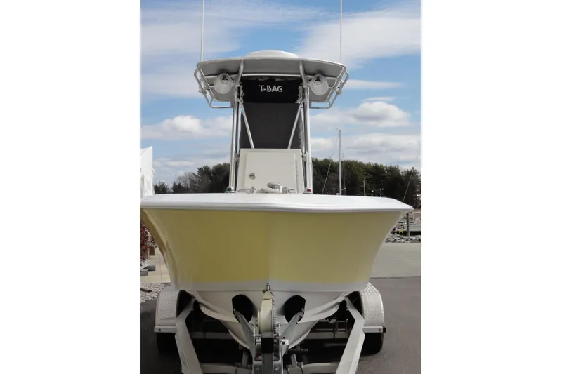 Slide: The Image of 2012 Contender 25 Tournament boat on trailer, front view, under a cloudy sky. - 8