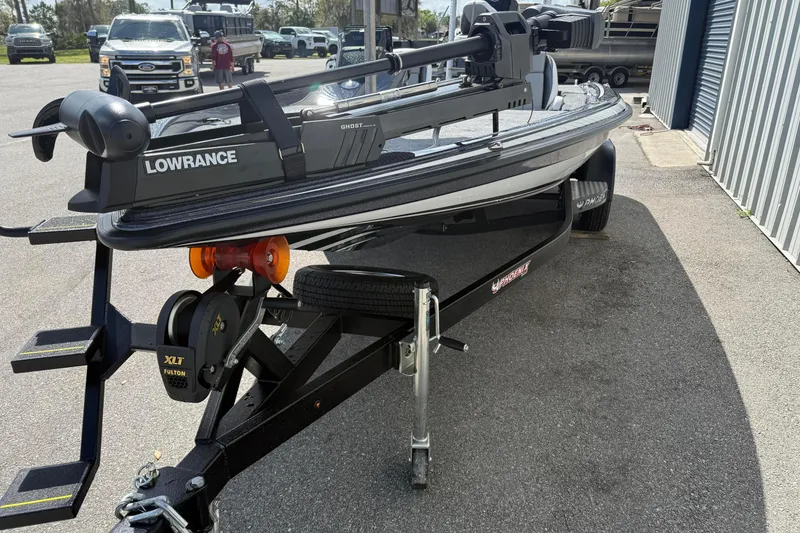 Slide: The Image of 2025 Phoenix 819 ZXL boat on trailer with Lowrance equipment, parked outdoors. - 10